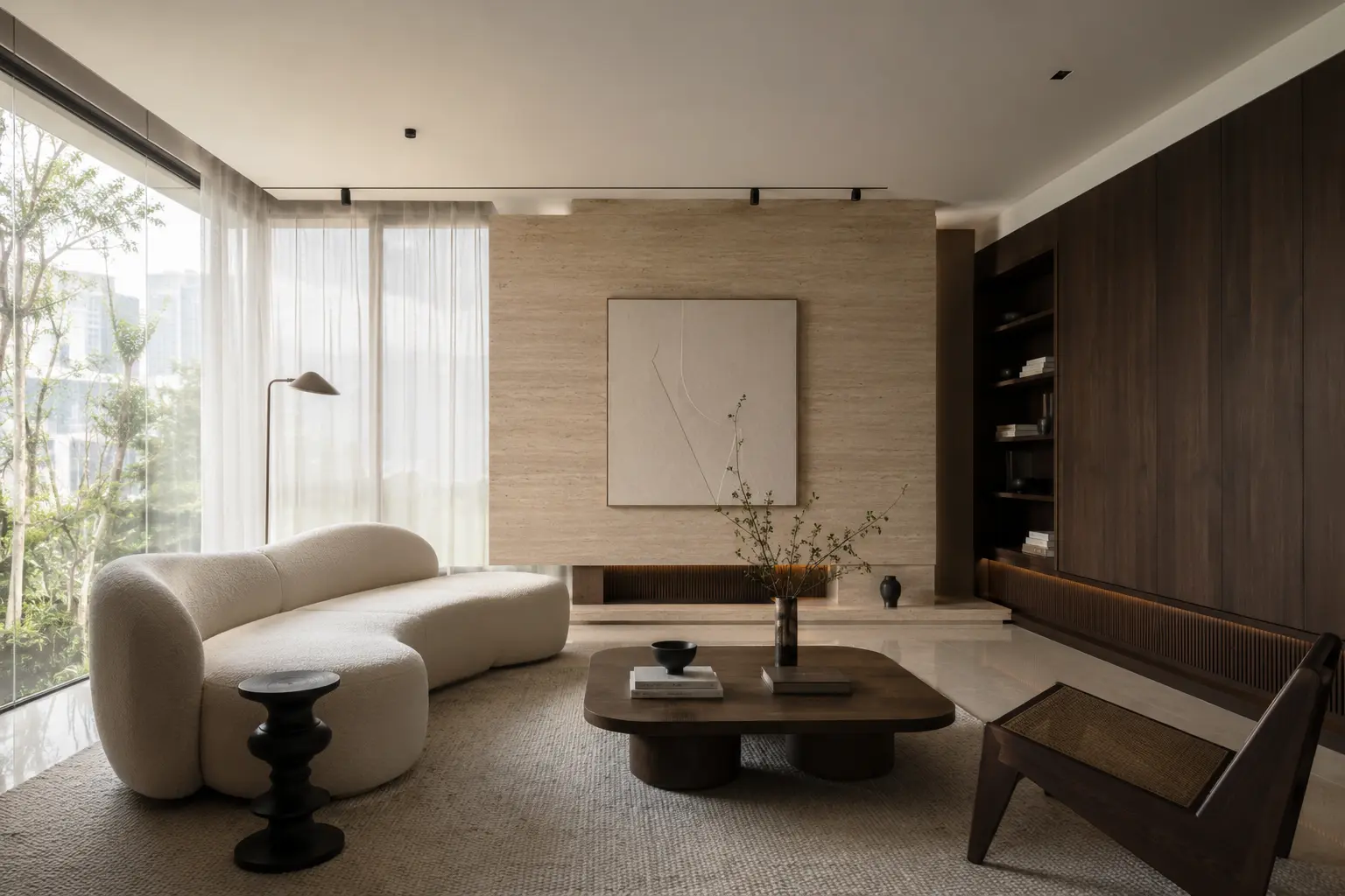 Warm minimal living room with a curved boucle sofa, walnut coffee table and a travertine feature wall, opening onto a green outlook through floor-to-ceiling glazing.